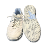 White women's Nike running shoes with laces and patterned outsoles, front and bottom view on white background.