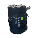 Black Thermarest Trail Pro self-inflating mattress in its matching stuff sack against a white background.