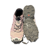 Purple Salomon women's trail running shoes with patterned outsoles, front view with one shoe showing the sole against a white background.