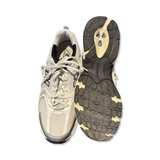 White New Balance 530 men's sneakers, shown from the front and with the sole facing upward against a white background.
