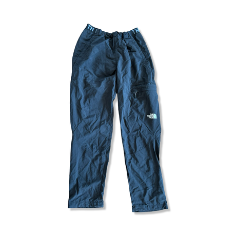 Men's black The North Face hiking pants with a logo on the thigh, shown against a white background.