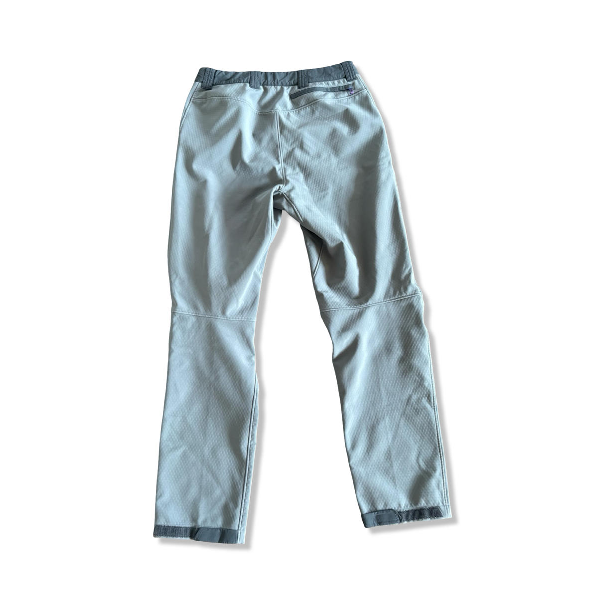 Men's grey Patagonia hiking pants with a zippered back pocket, back view on a white background.