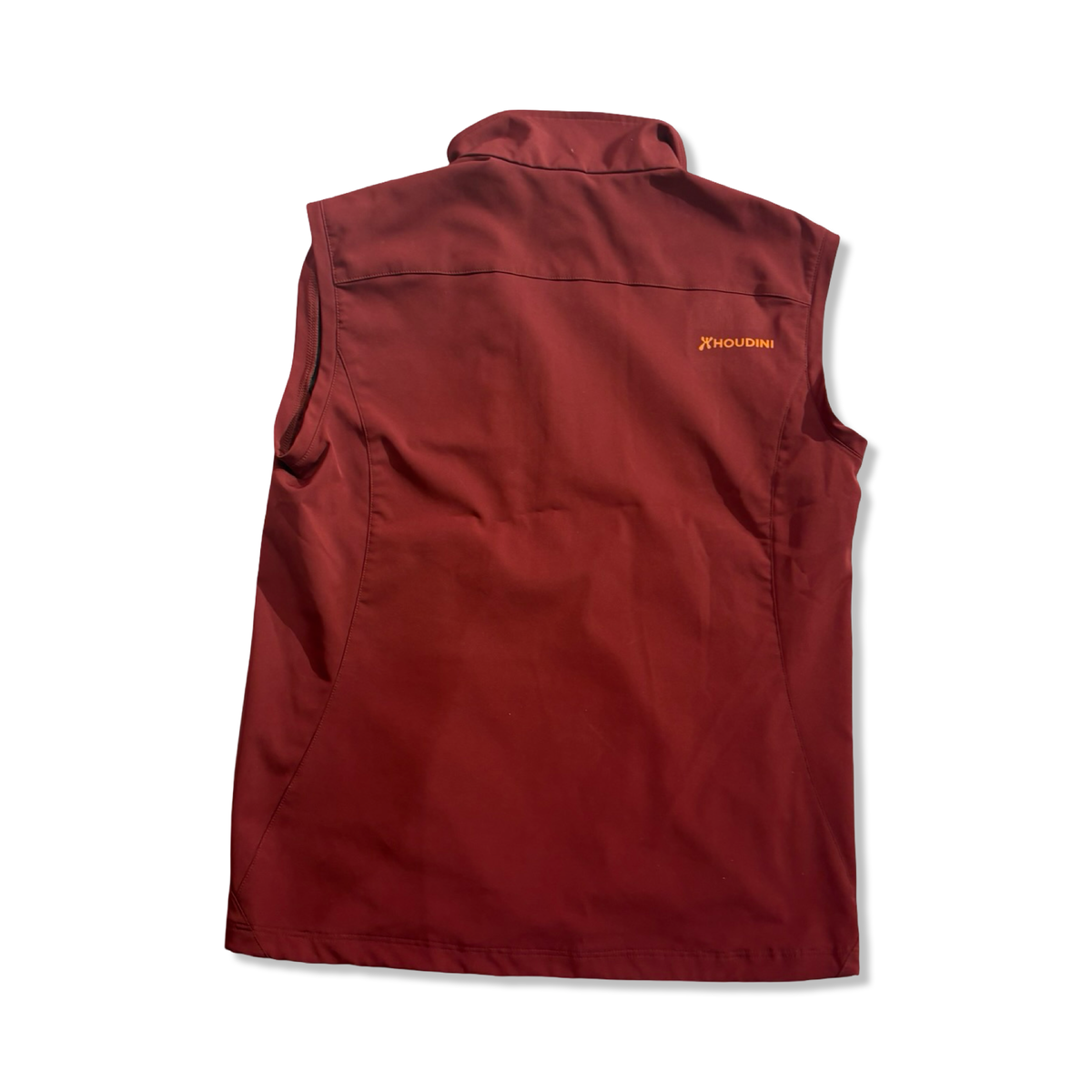 Back view of a red Houdini men's vest against a white background.
