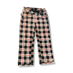 Red, black and white plaid women's ski pants from Vans, front view against a white background.