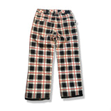 Back view of a red, black, and white plaid Vans women's ski pants against a white background.