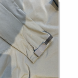 Close-up of the sleeve and cuff of the gray Haglöfs ROCA II Hood men's hybrid jacket, showing a stain.