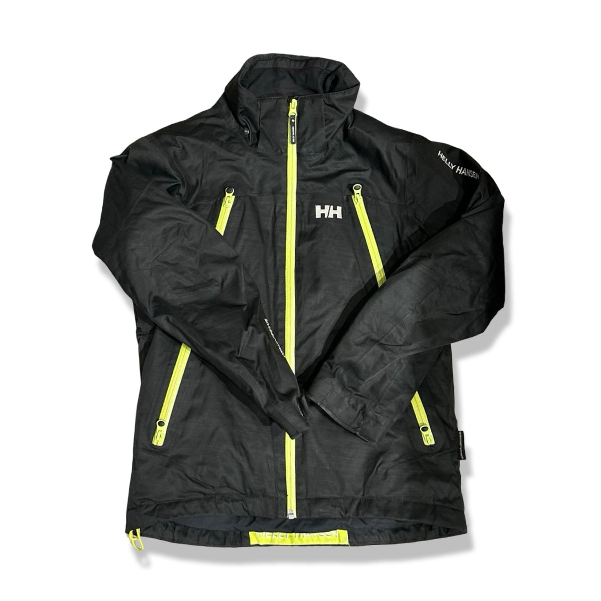 Black Helly Hansen children's ski jacket in size 152 with yellow zippers, front view against a white background.