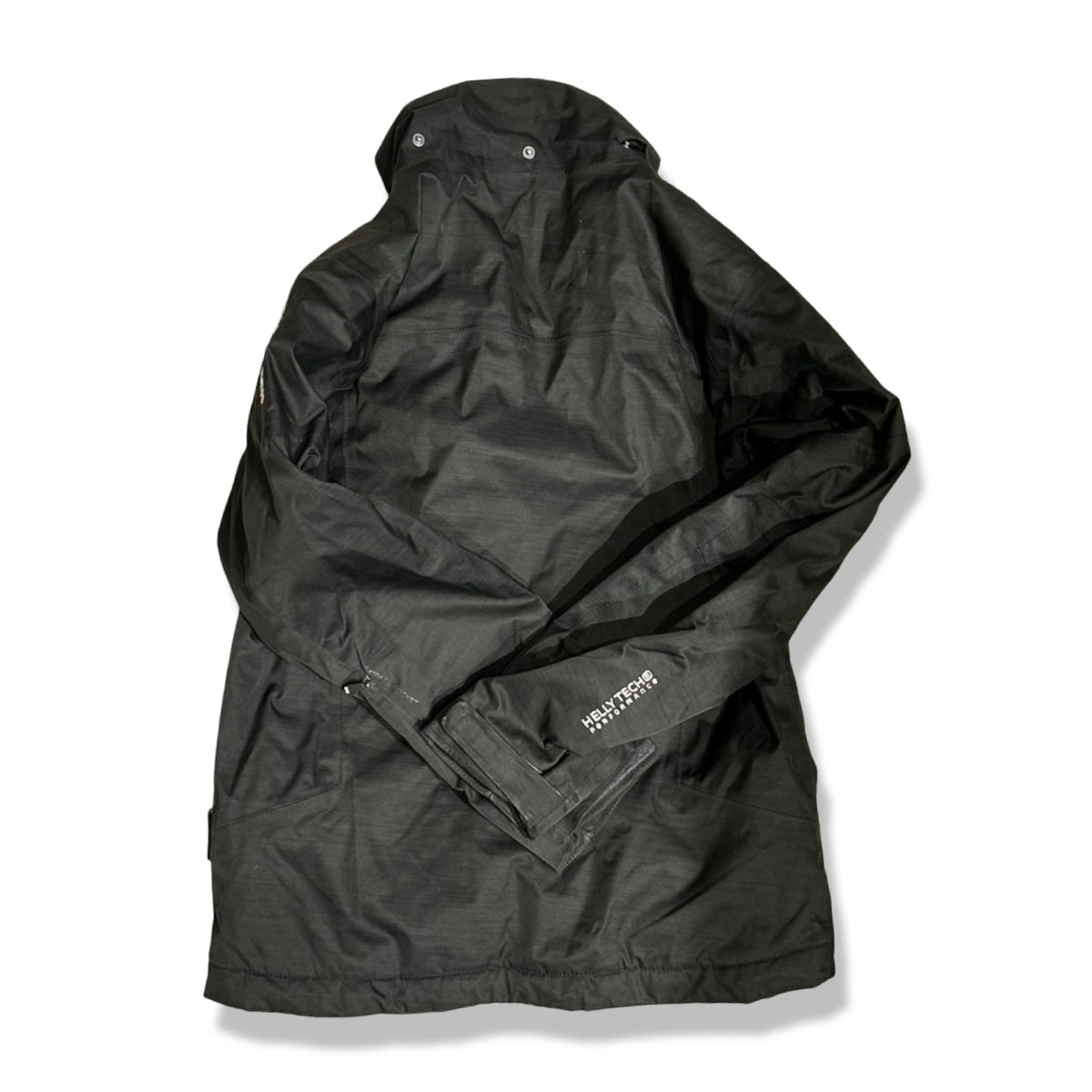 Back view of a black Helly Hansen children's ski jacket in size 152 against a white background.