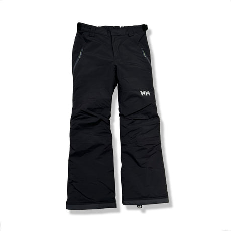 Black Helly Hansen kids' ski pants with zippered pockets, front view against a white background.