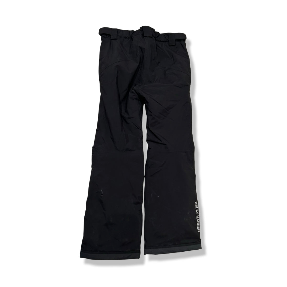 Back view of a pair of black children's ski pants from Helly Hansen against a white background.