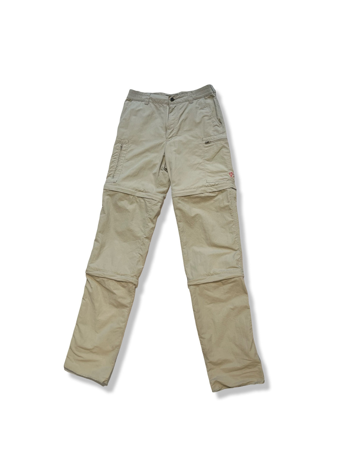 Beige vandringsbyxor med zip-off från Fjällräven för dam, fotograferade framifrån mot en vit bakgrund.