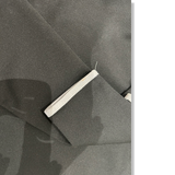 Close-up of the sleeve and minor stain on the black Peak Performance training shirt.
