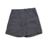 Dark grey Haglöfs Mid Hemp women's shorts with large front pockets, photographed against a white background.