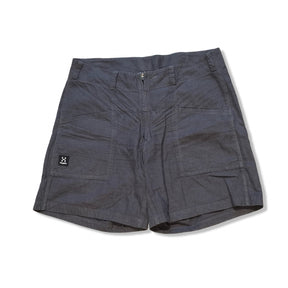 Dark grey Haglöfs Mid Hemp women's shorts with large front pockets, photographed against a white background.