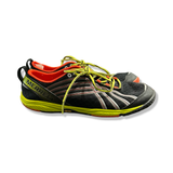 Black Merrell women's training shoes with yellow details, side view against a white background.