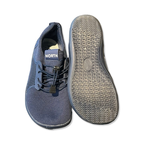 Mörkblå North Footwear sneakers för dam, där en sko visas uppifrån och den andra visar sulans mönster.