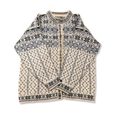 White and blue Dale of Norway women's lusekofta cardigan with pattern and buttons, front view against a white background.