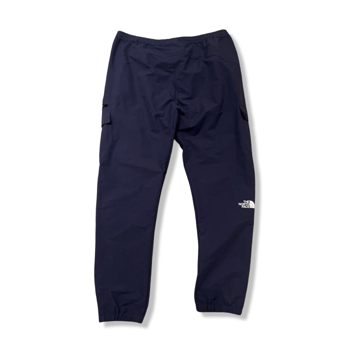 Back view of a blue The North Face men's activewear pants against a white background.