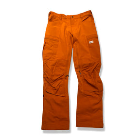 Orange re-adventure women's hiking pants, front view against a white background.