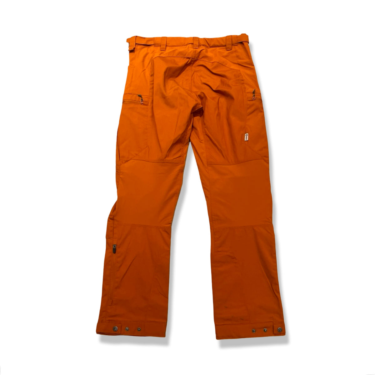Back view of a pair of orange Re-Adventure women's hiking pants against a white background.