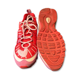 Women's Nike Air Max 98 sneakers in red and pink, featuring a top-down view and the textured sole.