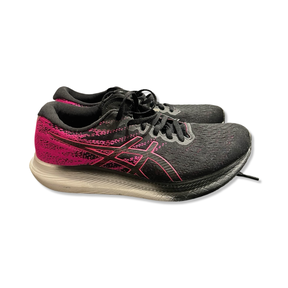 Black and pink Asics women's training shoes, side view against a white background.