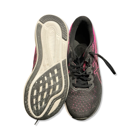 A pair of black and pink Asics women's training shoes where one shoe shows the outsole and the other is seen from the front.