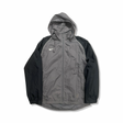 Grey and black Nike women's hooded windstopper jacket, front view against a white background.