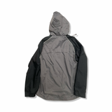 Grey and black hooded Nike women's windstopper jacket, back view against a white background.