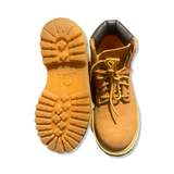 Brown children's boots from Timberland, shown with an outsole and a front view against a white background.