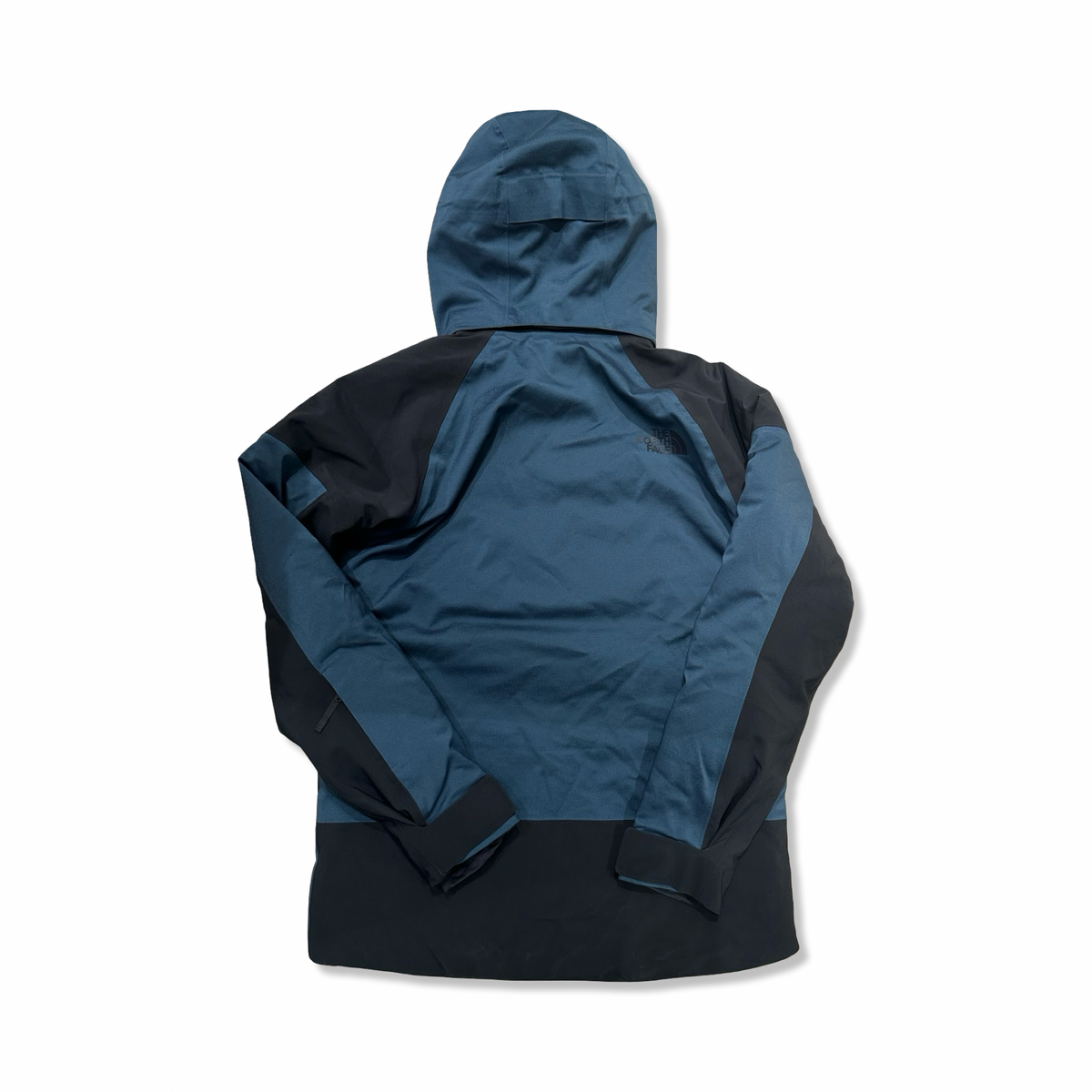 Back view of a blue and black The North Face men's hooded ski jacket against a white background.