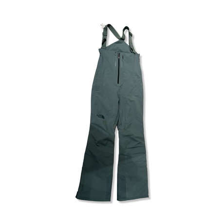 Green The North Face women's ski pants with suspenders, front view against a white background.