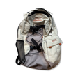 Beige Dakine backpack with gray accents, orange embroidered logo, and black straps on a white background.