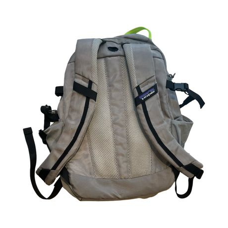 Grey Patagonia backpack with padded shoulder straps and mesh panel, back view against a white background.