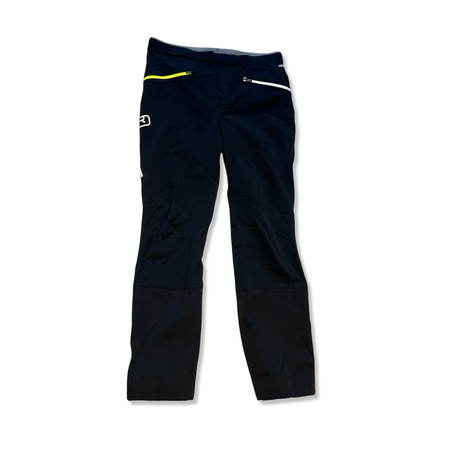 Black Ortovox hiking pants with yellow and white details, front view against a white background.
