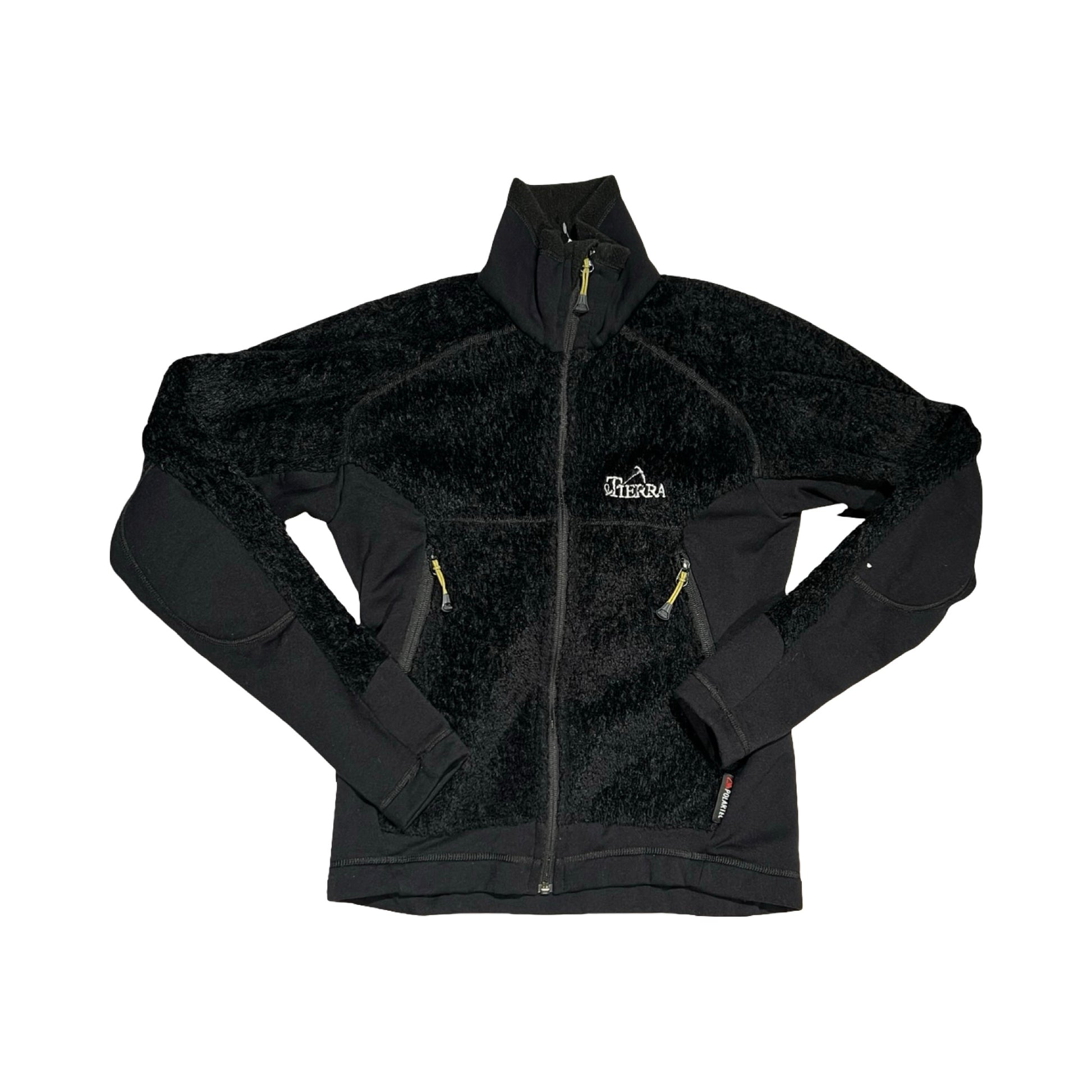 Tierra fleecetröja för dam i svart. Tröjan har en hög krage och heldragen dragkedja och är fotograferad platt framifrån mot en vit bakgrund.