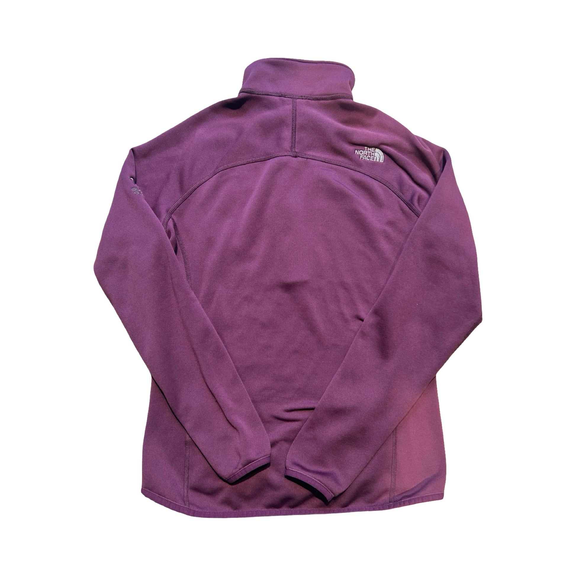 Baksidan av The North Face Summit fleecetröja för dam i lila. Tröjan är fotograferad platt mot en vit bakgrund.