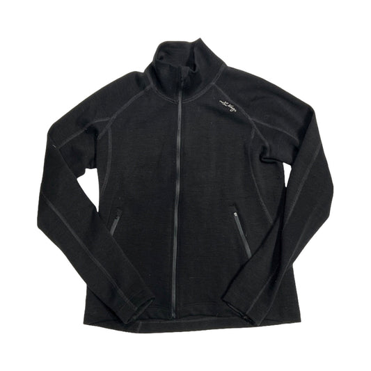 Lundhags Merino Full Zip funktionströja för dam i svart. Tröjan har en hög krage och heldragen dragkedja och är fotograferad platt mot en vit bakgrund.