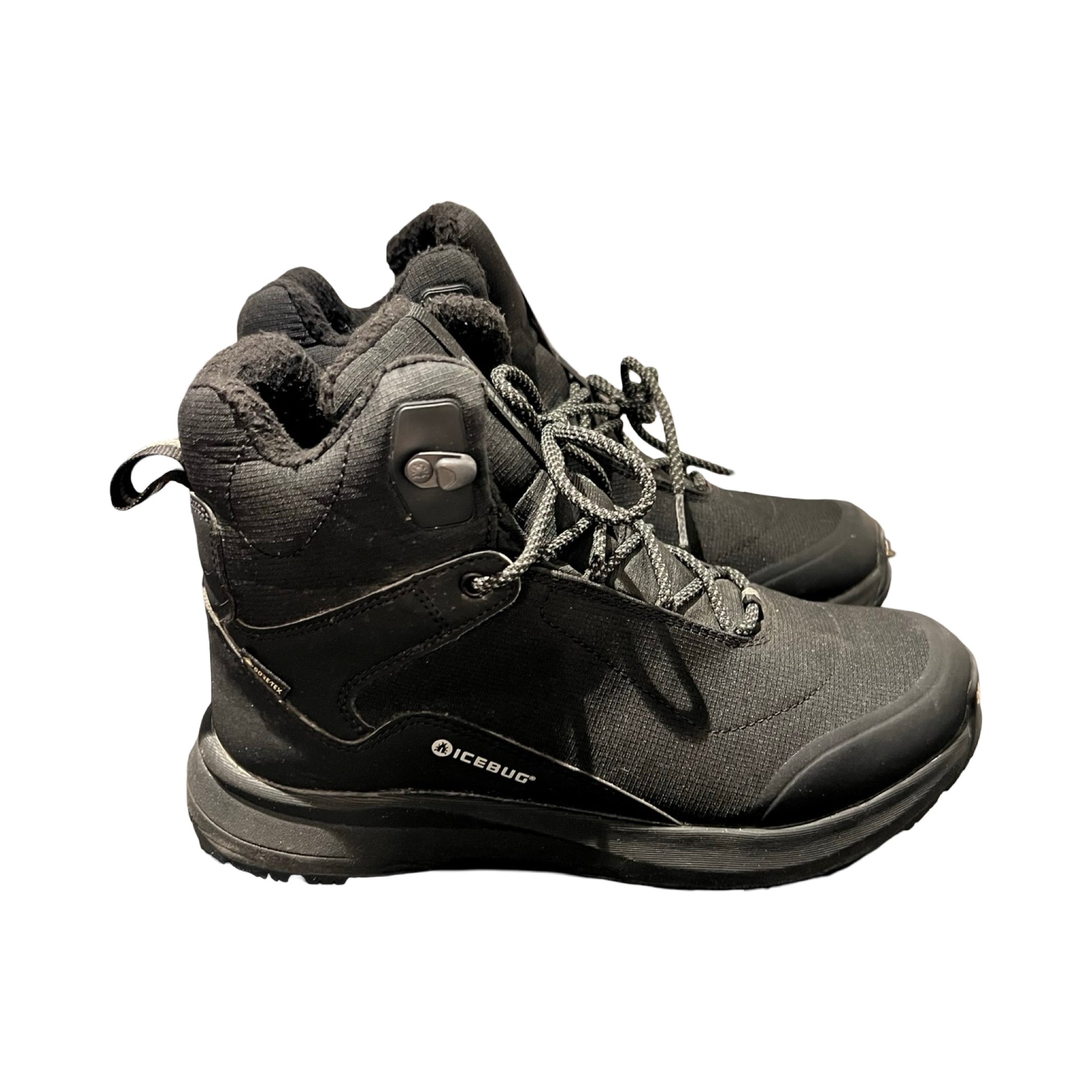 Icebug Pace kängor för dam i svart. Kängorna är fotograferade från sidan mot en vit bakgrund.