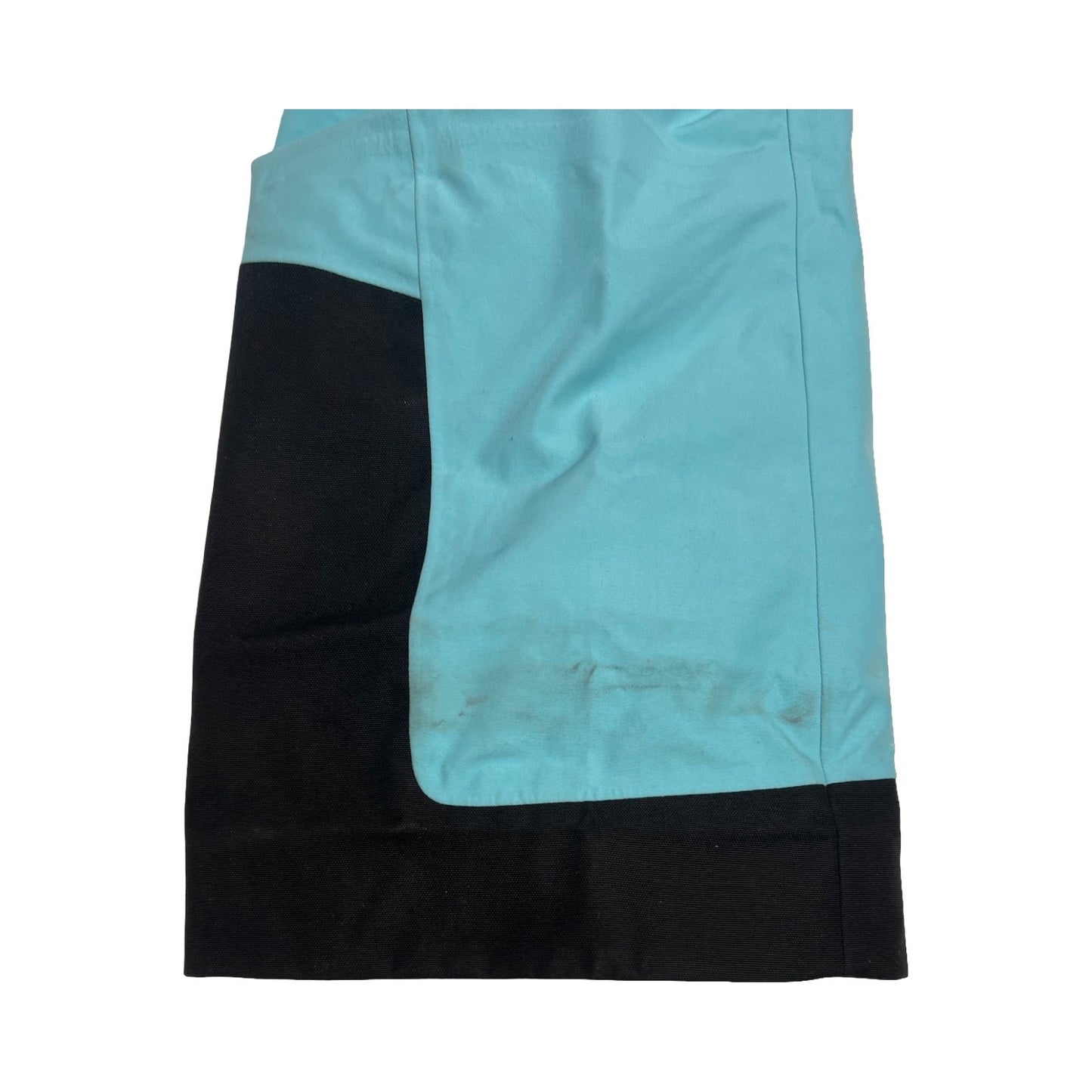 Närbild på fläckar vid benslutet på Peak Performance GTX Pro skalbyxa för dam i ljusblått och svart.