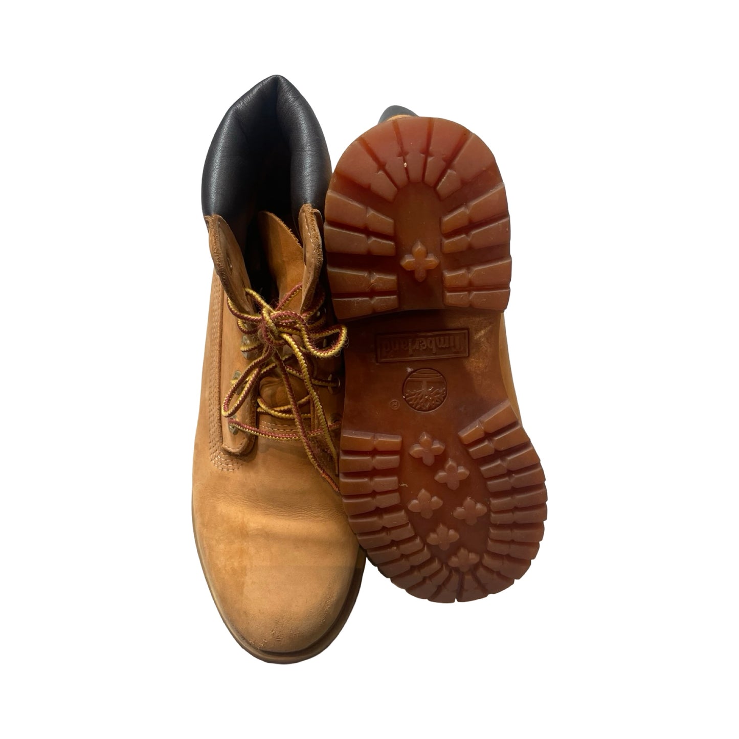 Beige Timberland Original kängor för dam, där en sko visas framifrån och den andra visar undersidan mot vit bakgrund.