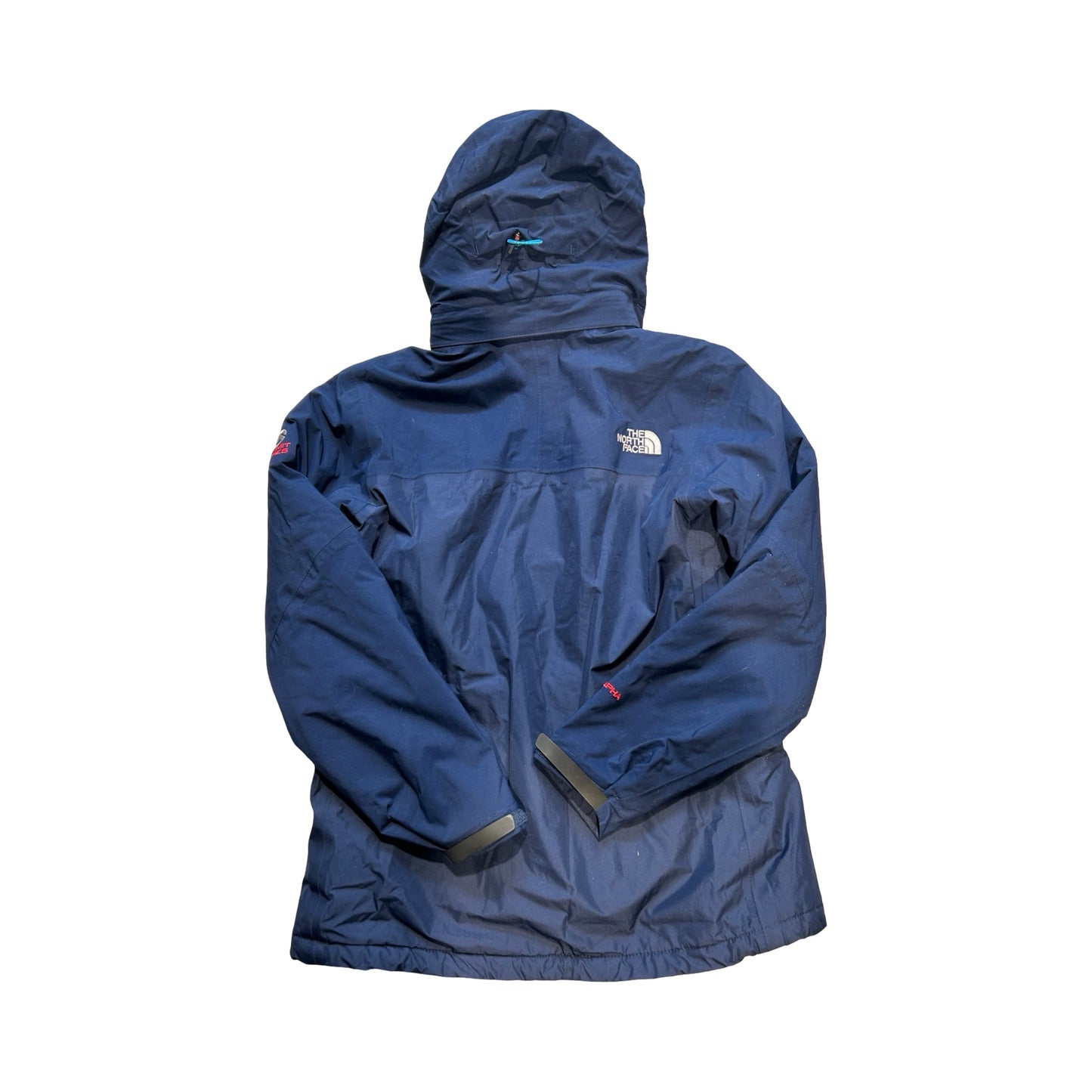 Baksidan av The North Face Summit skidjacka för dam i mörkblått, fotograferad mot en vit bakgrund.