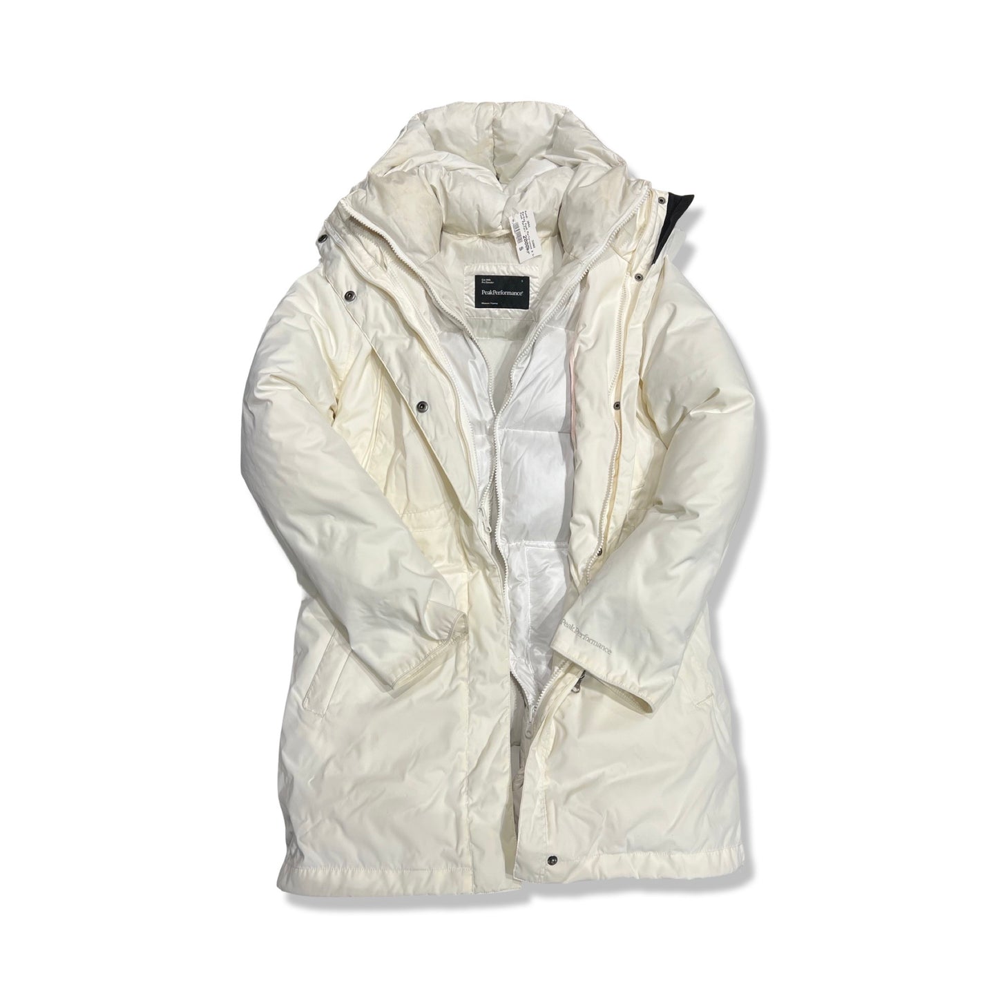 Peak Performance 3-i-1 parkas för dam i vitt. Jackan har huva och är fotograferad framifrån mot en vit bakgrund med den inre dunjackan synlig.