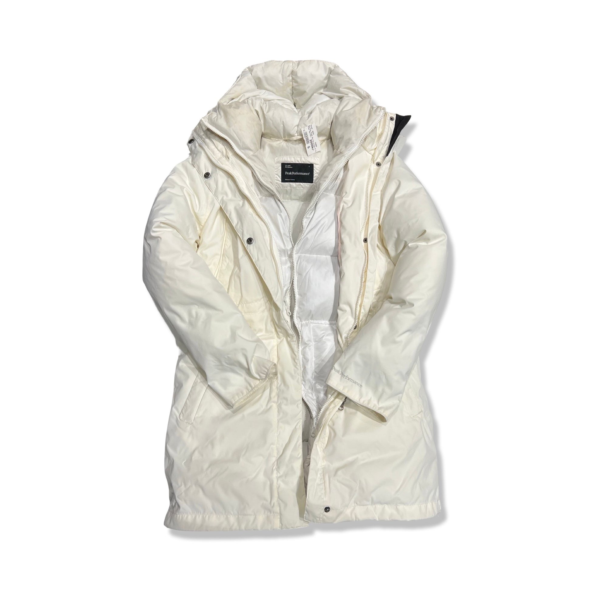 Peak Performance 3-i-1 parkas för dam i vitt. Jackan har huva och är fotograferad framifrån mot en vit bakgrund med den inre dunjackan synlig.