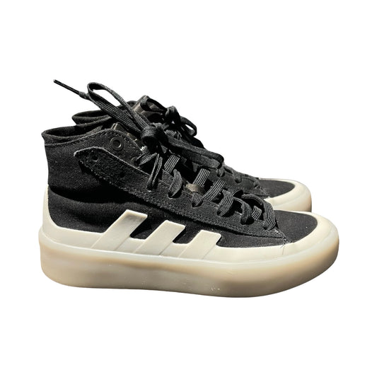 Höga Adidas sneakers för dam i svart med tjock, benvit sula. Skorna är fotograferade från sidan mot en vit bakgrund.