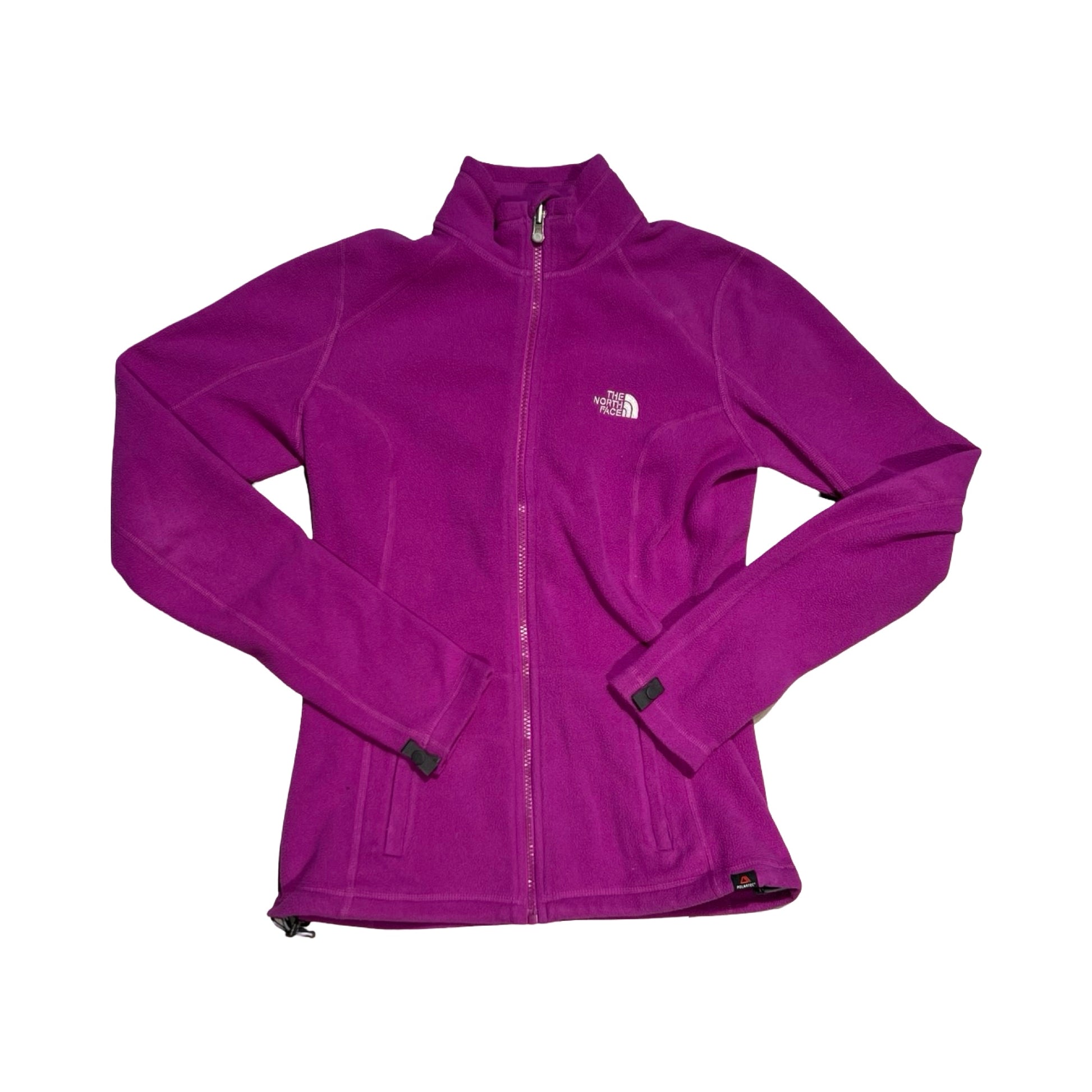 The North Face fleecetröja för dam i lila. Tröjan har en hög krage och heldragen dragkedja och är fotograferad platt mot en vit bakgrund.