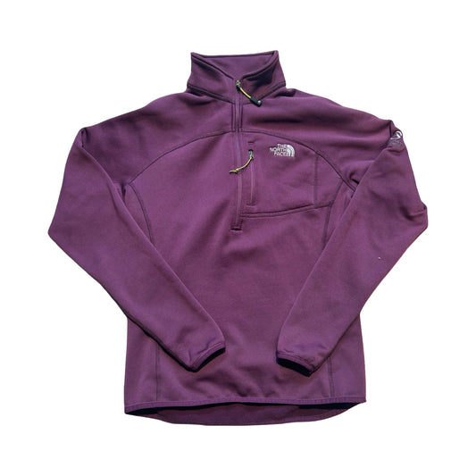 The North Face Summit fleecetröja för dam i lila. Tröjan har en hög krage med dragkedja och en bröstficka och är fotograferad framifrån mot en vit bakgrund.