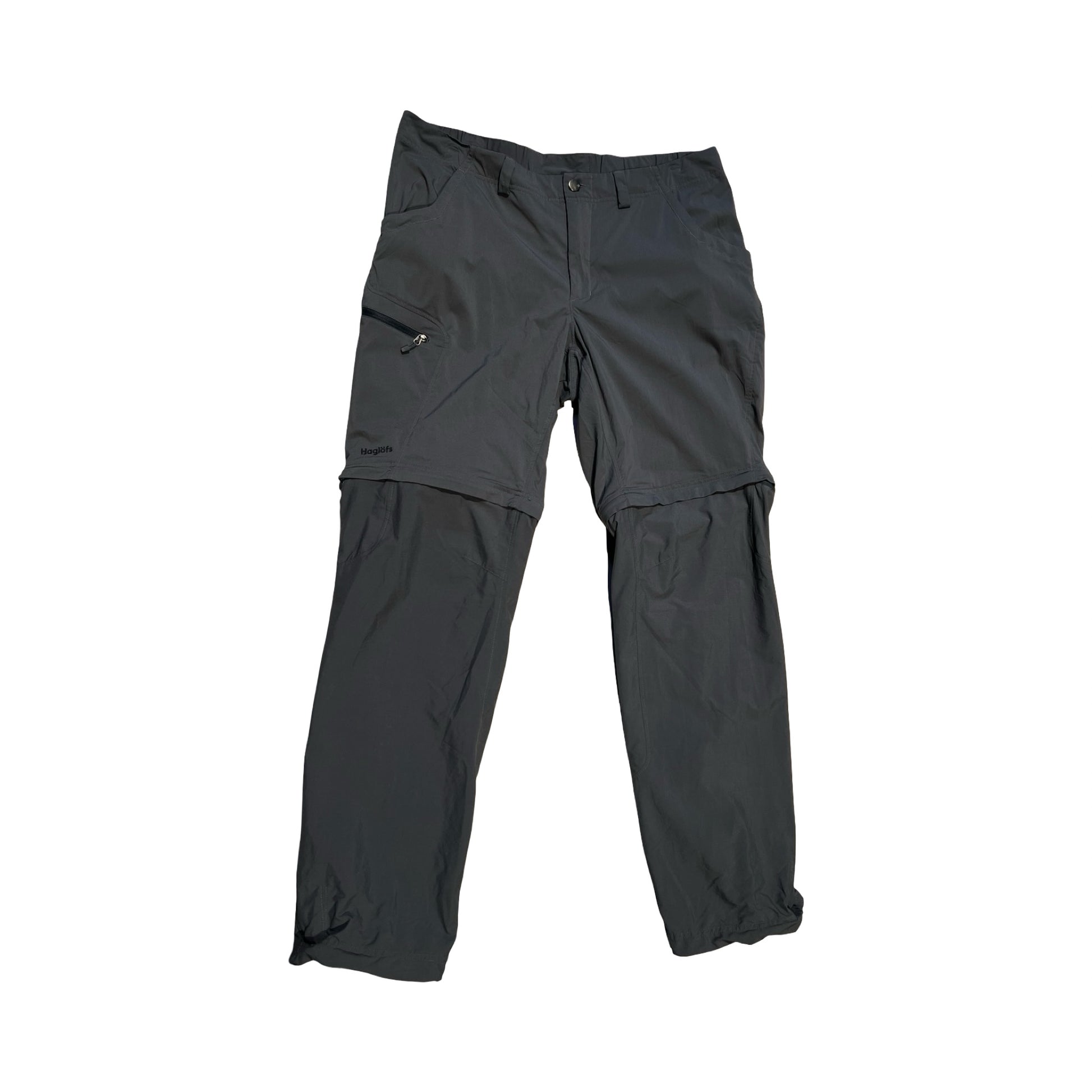 Haglöfs zip-off funktionsbyxor för dam i grått. Byxorna är fotograferade platt framifrån mot en vit bakgrund.